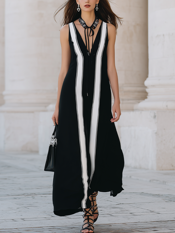 Black Sleeveless Long Dress With Black And White Striped Panels.